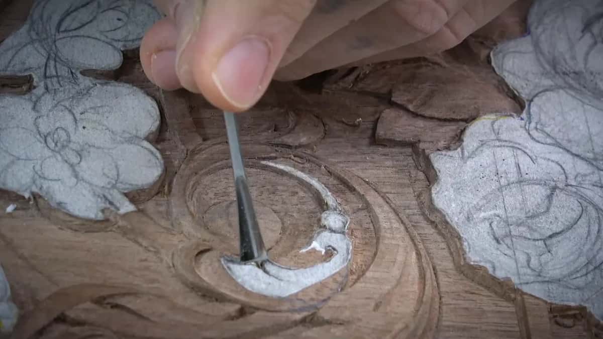 Dark slim gouge standing upright inside the carved spiral
