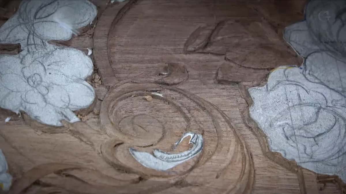 Nothing but wood in the frame, shavings caught in the hollows, a chalked leaf either side