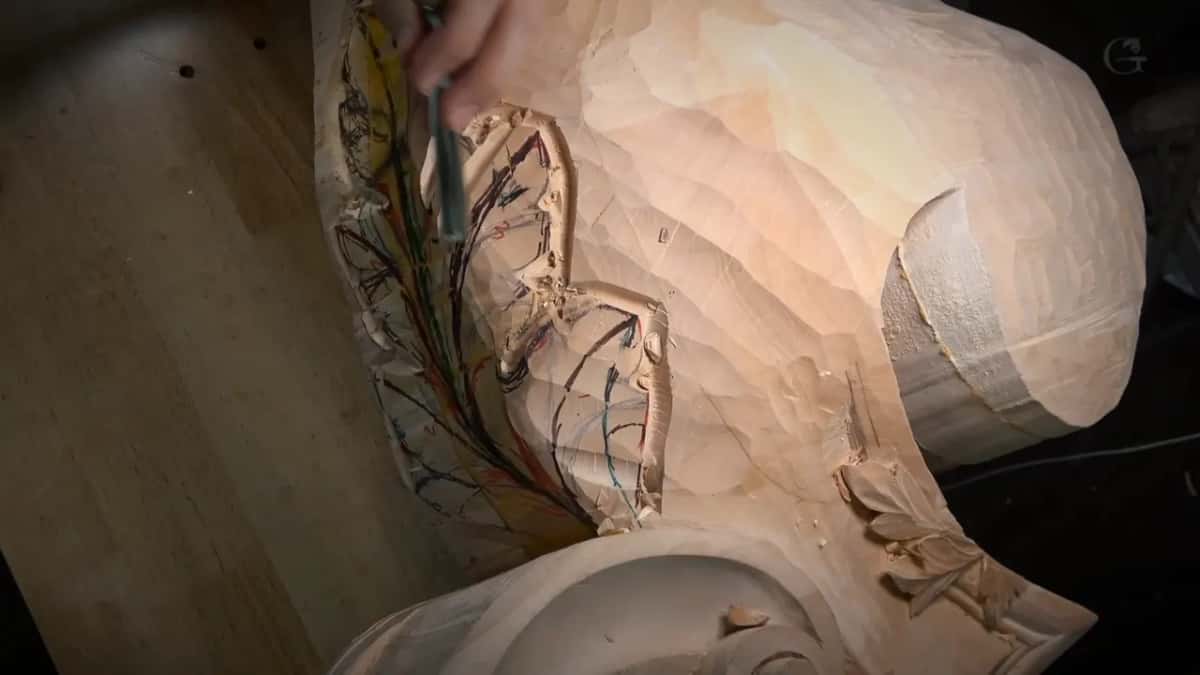From above, a gouge sits in a hollow of the leaf, with the big scroll to the right