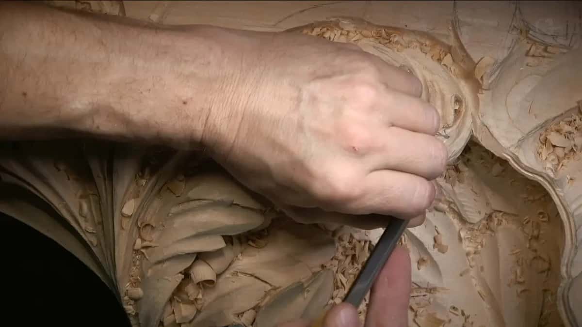 Held low, the gouge sits against the rim of a deep carved hollow