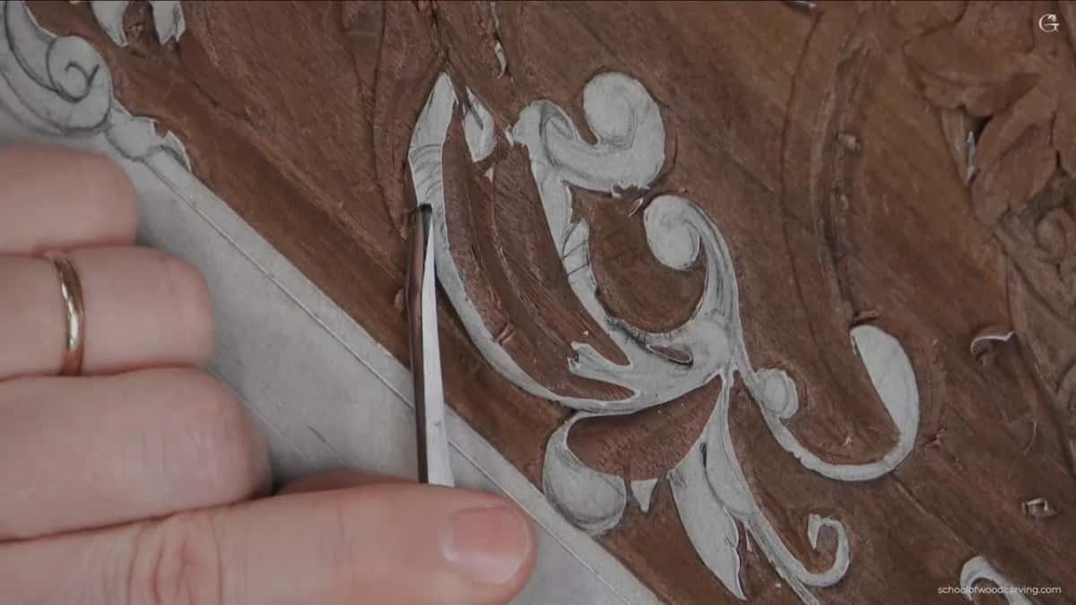 A ringed hand and a curved blade taking the shape down to a single consistent depth.