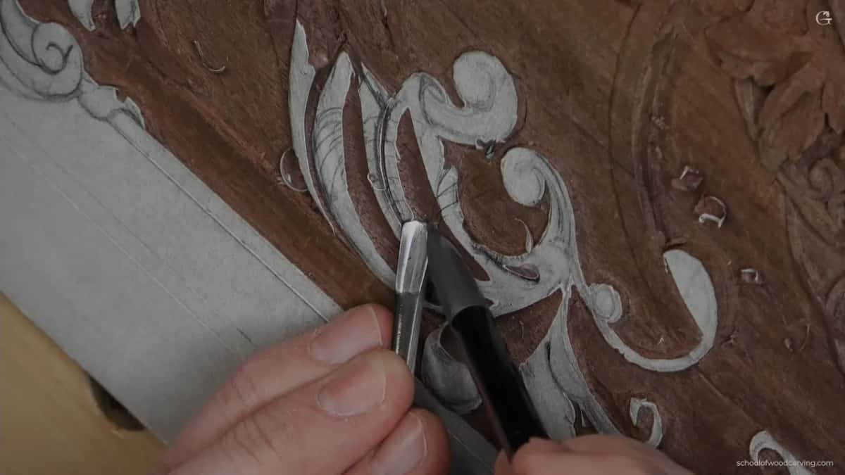 Two hands with the tool laid over toward the line instead of standing upright on it.