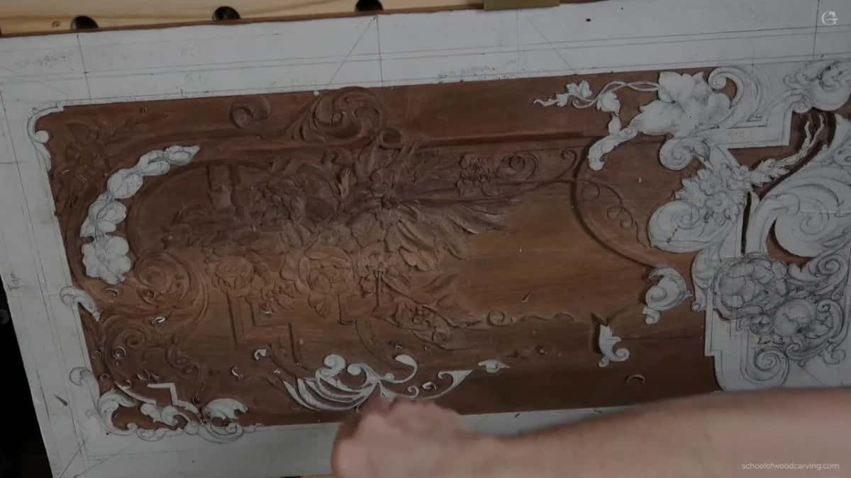 A hand on the whole board while he works out which way light will travel across it once hung.