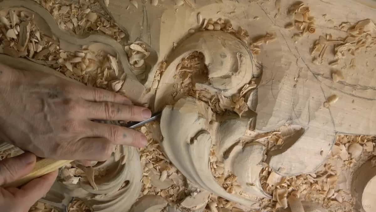 One hand on the handle, blade tucked under a curl.