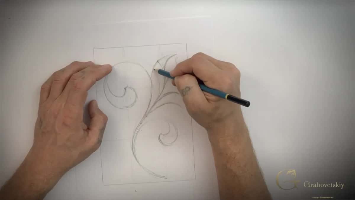Both hands in, one drawing and one steadying the sheet against the table
