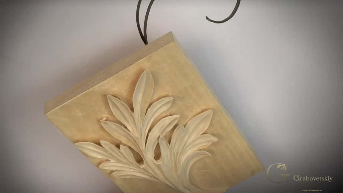 Carved acanthus with sharp tips on a pale block, seen from above
