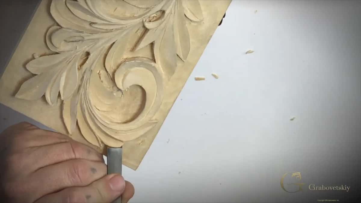 Gray handle in a hand, bottom left of the frame