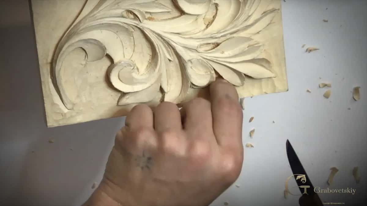 Hand on the panel, a knife blade below it