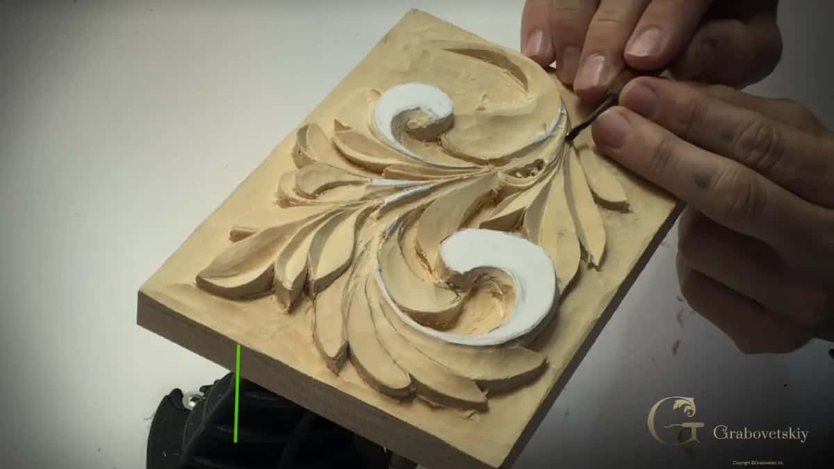 Fingertips on a tiny tool by the top curl