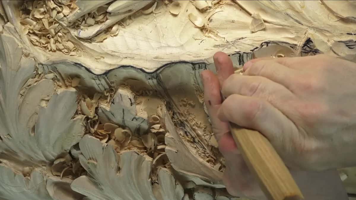 Light handle, blade down at the right end of the wavy rim.
