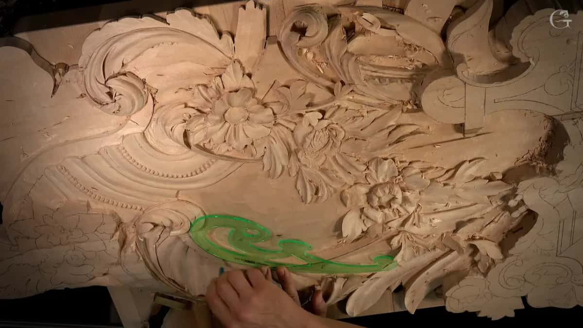 Green french curve laid flat on the carving
