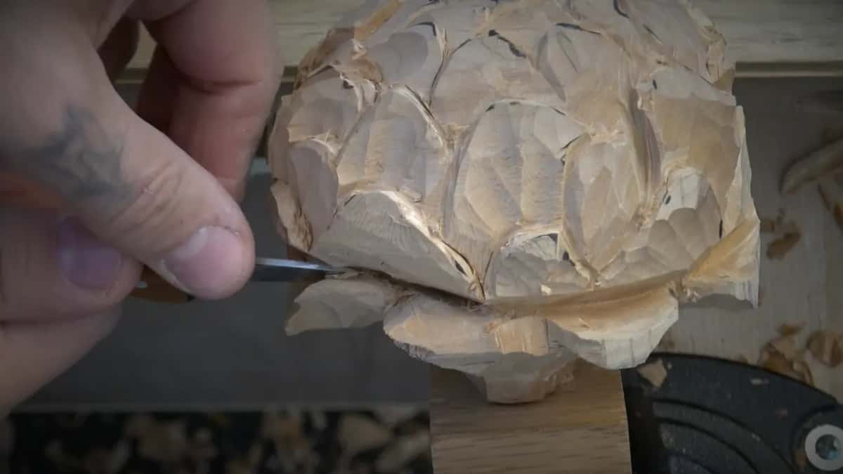 Working under the flower with a small tool, taking it in stages rather than one push.