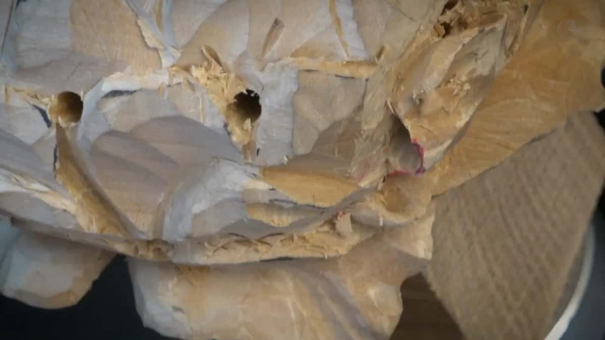 Carved petals with two drilled openings and red marker still on the rim between them.
