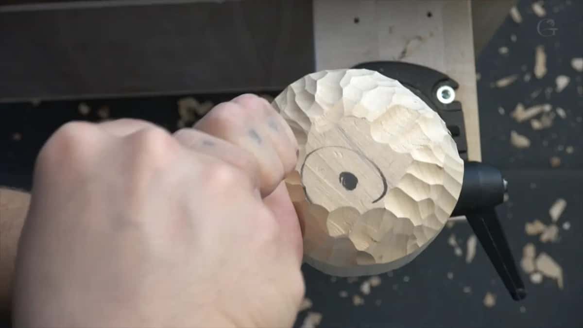 Held from above, scalloped all over, one screw showing.