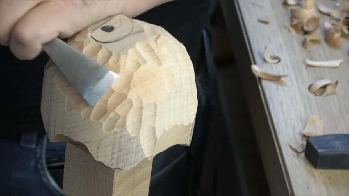 Wide flat gouge laid along the curve, taking the tops off the ridges without chasing them all.