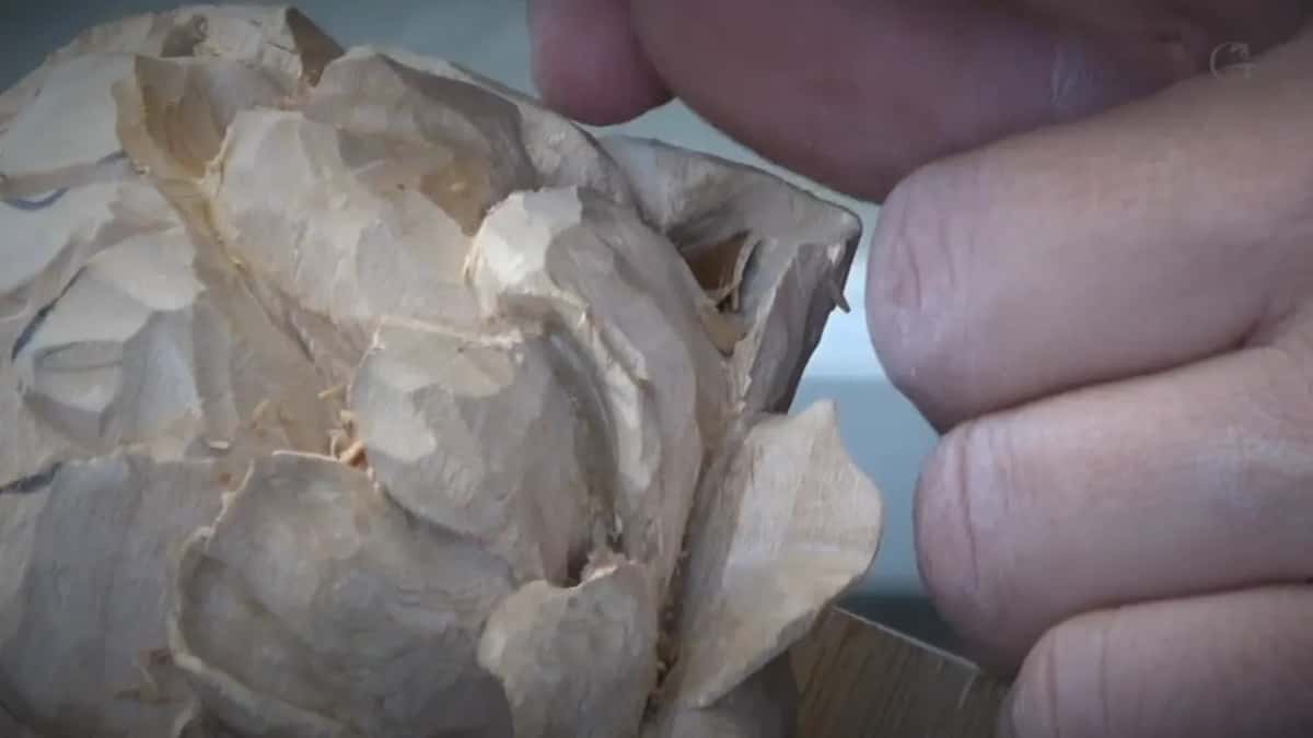 Knuckle beside carved petals.