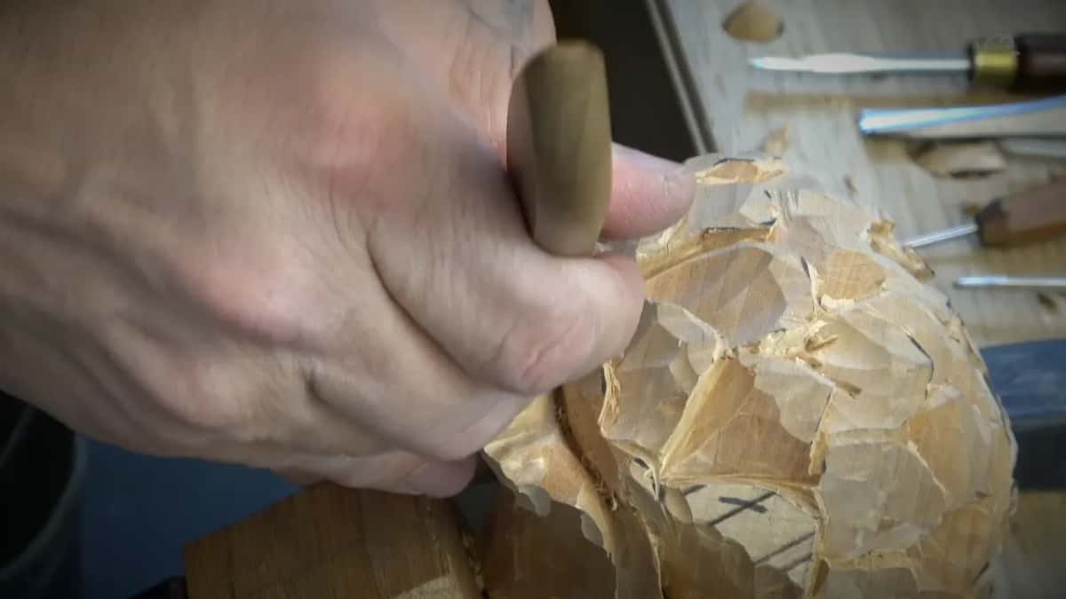 Brass ferrule in the fist, the first band of petals finished behind it.