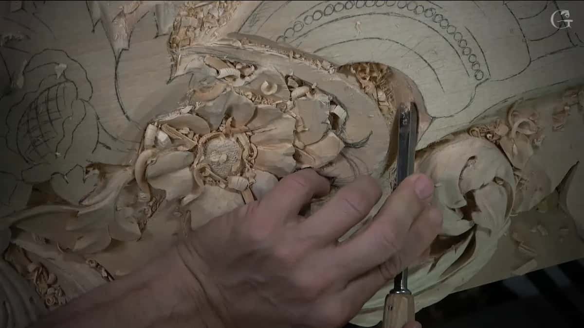 Narrow gouge held upright beside the scroll