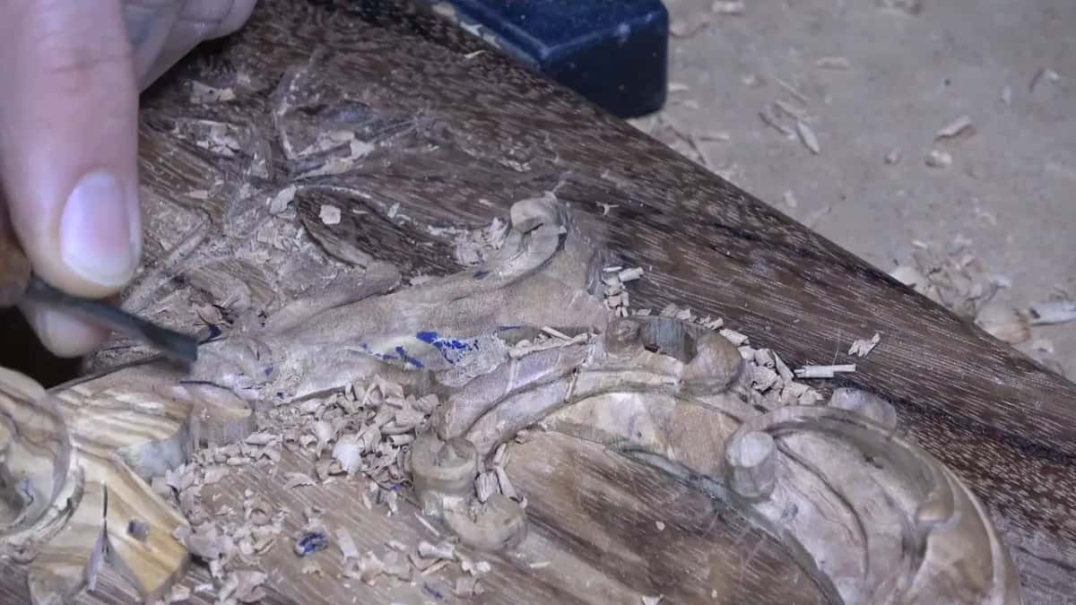 Small gouge working inside the curl, chips piling up around the blue marks left from the drawing