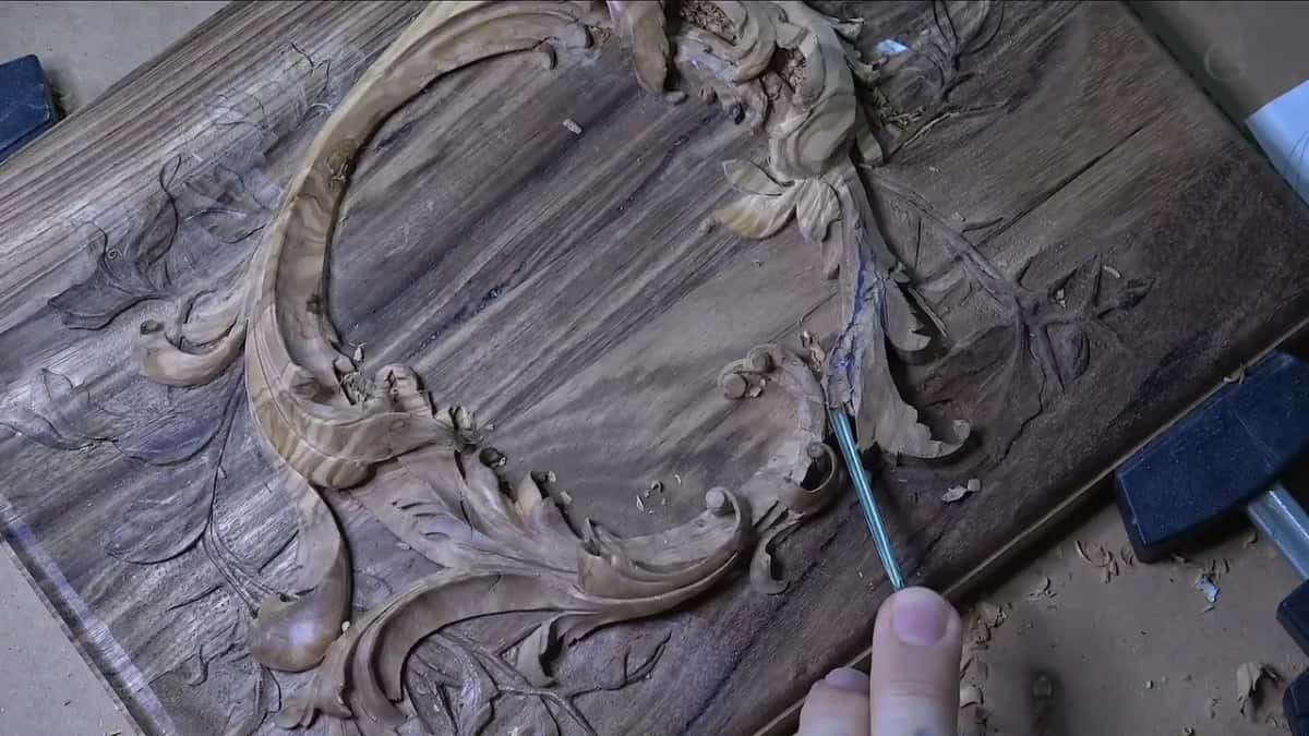 Olive wood oval rising off the dark acacia lid, with a narrow gouge in the waste on the right