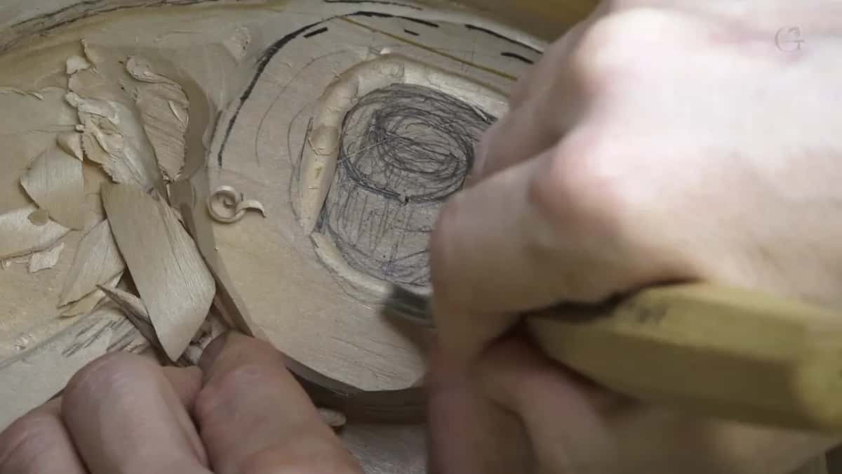 Fingers braced on the wood, a yellow handle steered into the pencil circle.