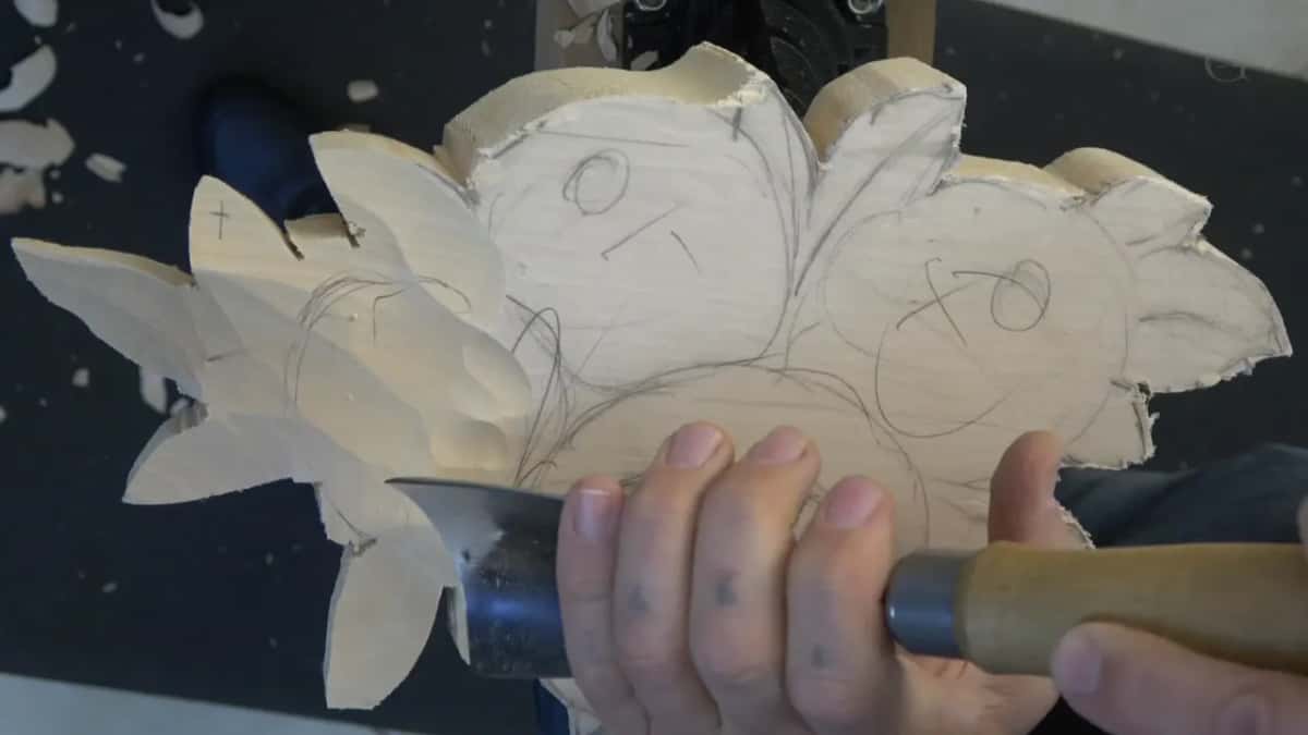Whole blank held up, every flower centre marked with a pencilled circle and a slash for its facing