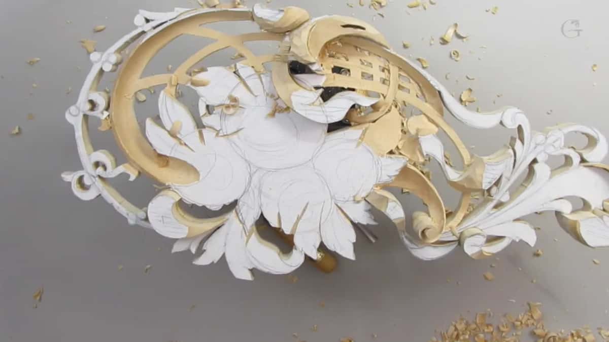 The panel alone under chips, spiral roughed and waiting for its corners to be cleaned