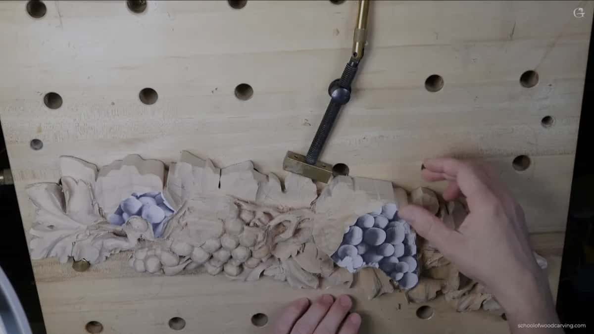 Roughed out class panel clamped to the bench, printed pattern still stuck across two grape bunches