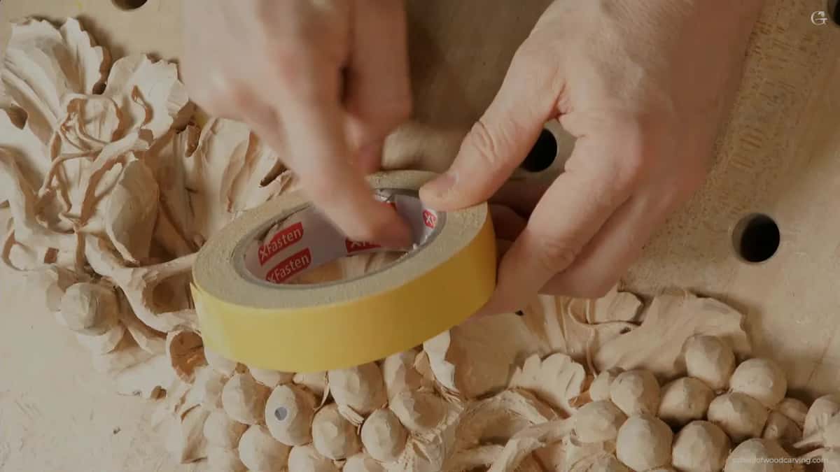 XFasten tape roll above the carving