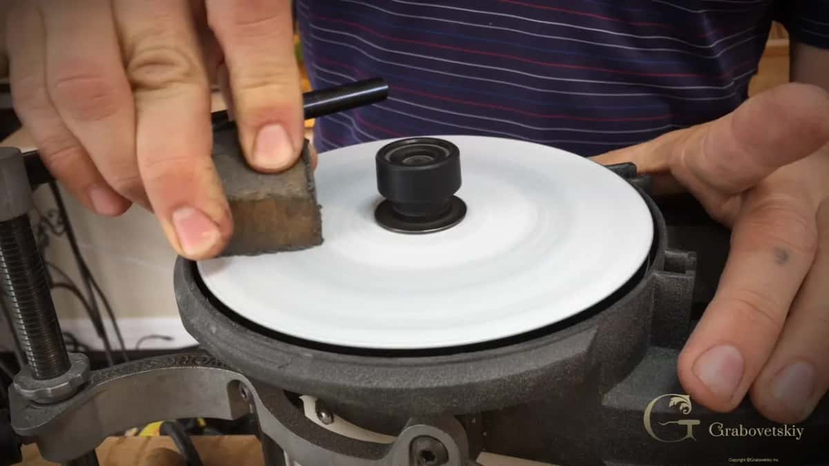 Rubber cleaning stick held to the turning abrasive.
