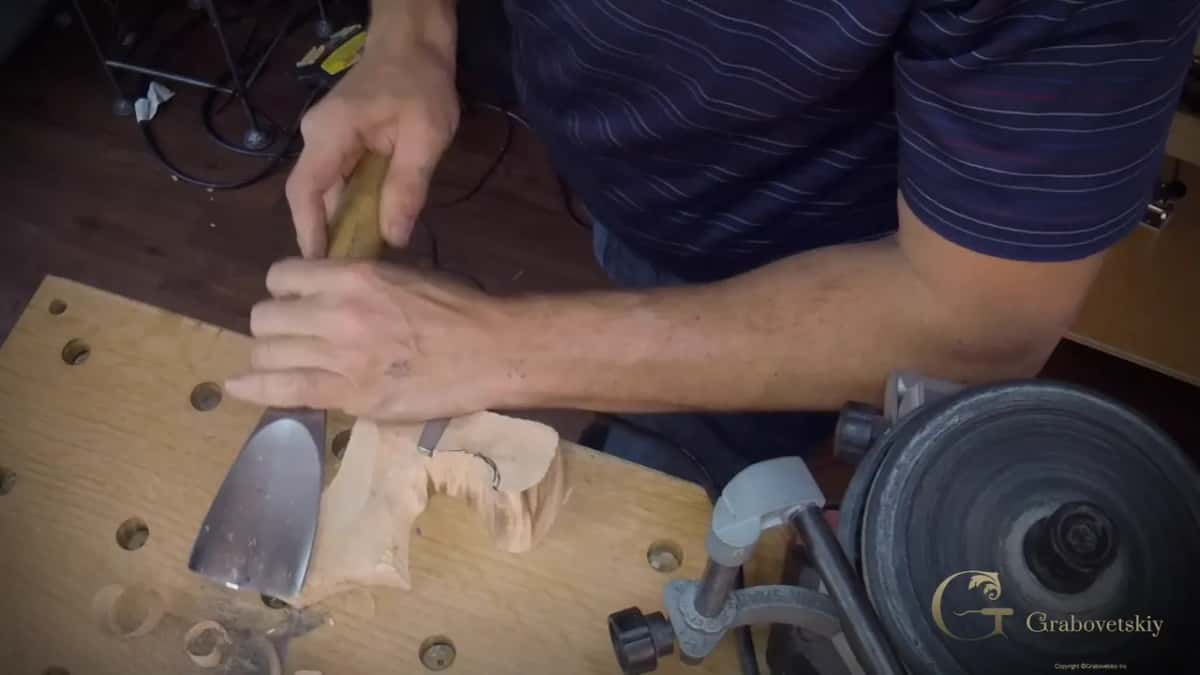 Curl of wood peeling up ahead of the blade.