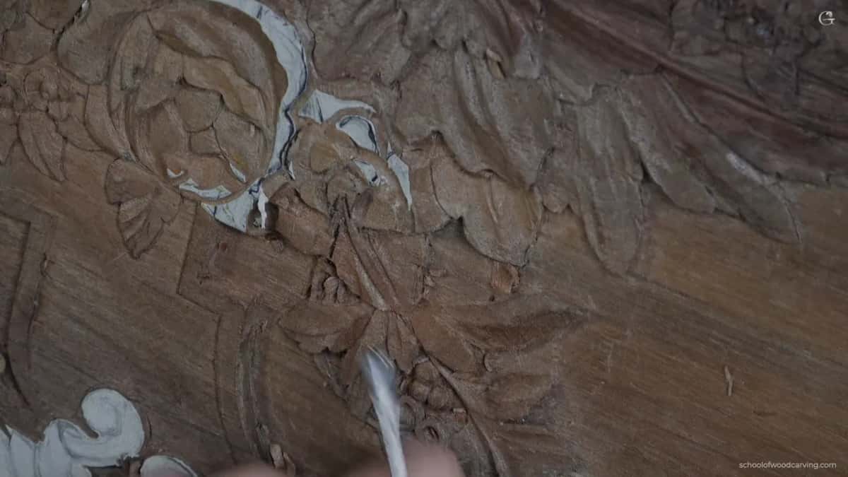 An unmarked old fishtail gouge, made before anybody stamped numbers on these, hollowing one side of a petal.