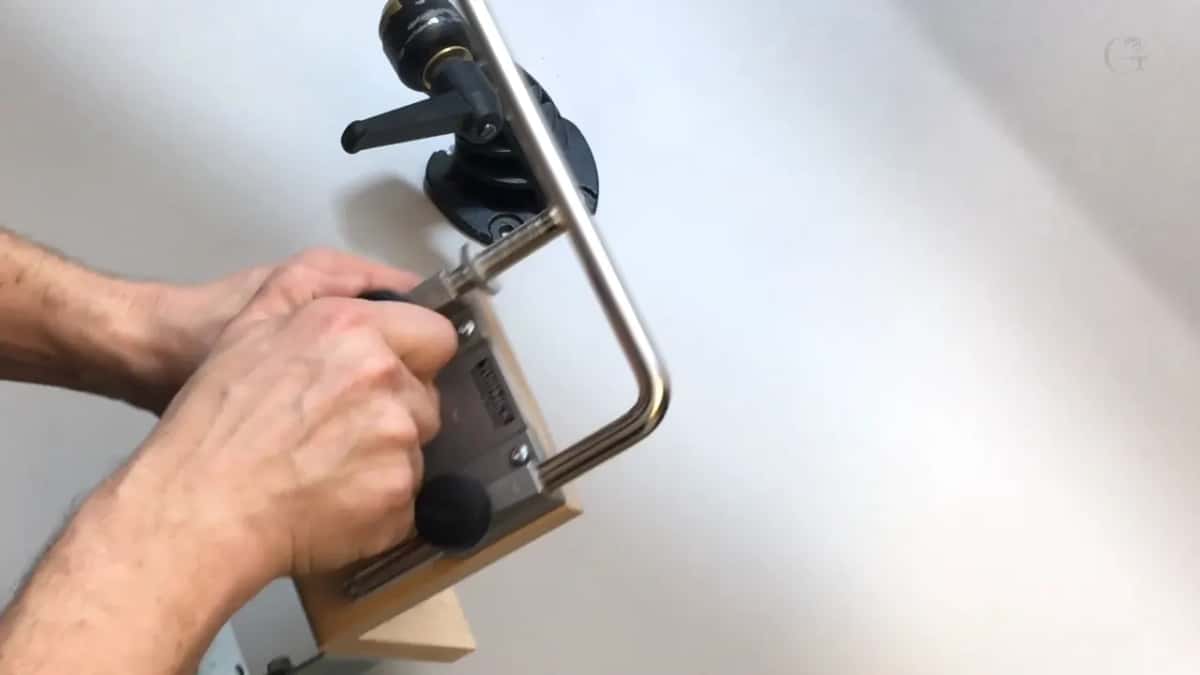 Bar seated in the bracket on its block of wood.
