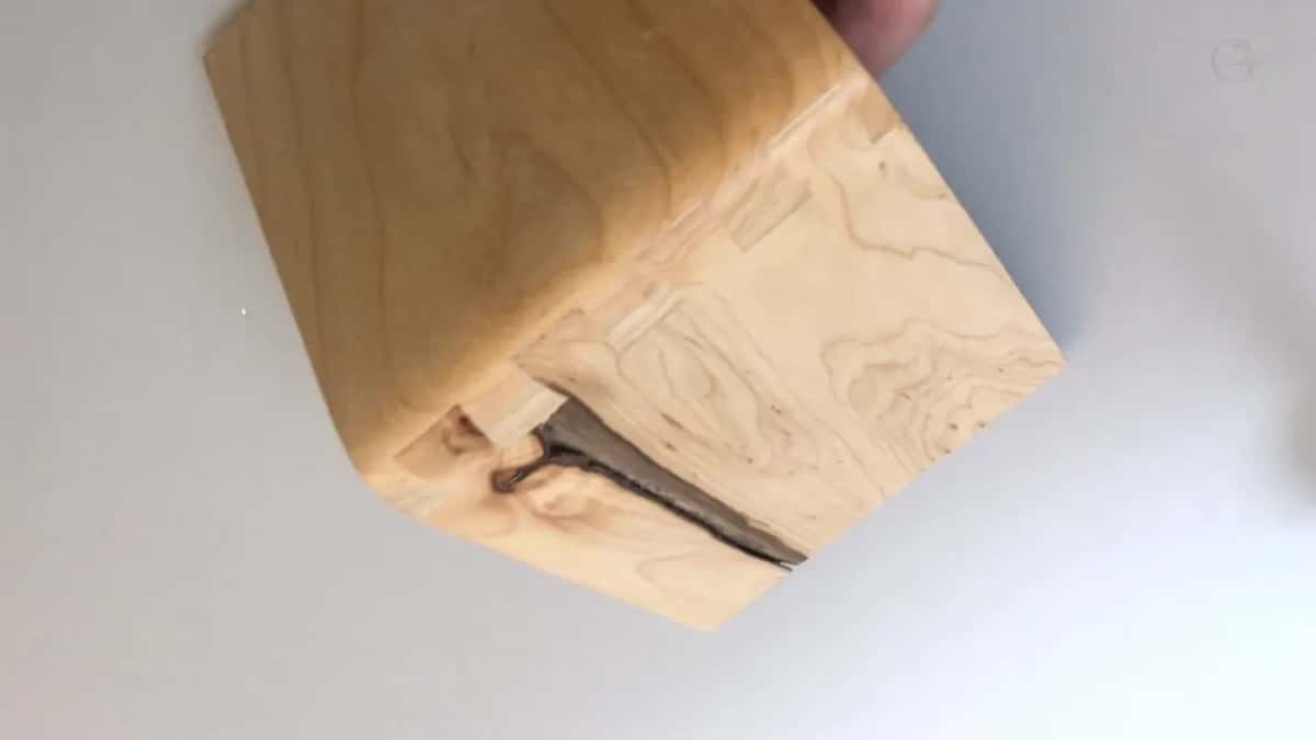 Same block turned over, the dovetail joint and a bark inclusion both showing.
