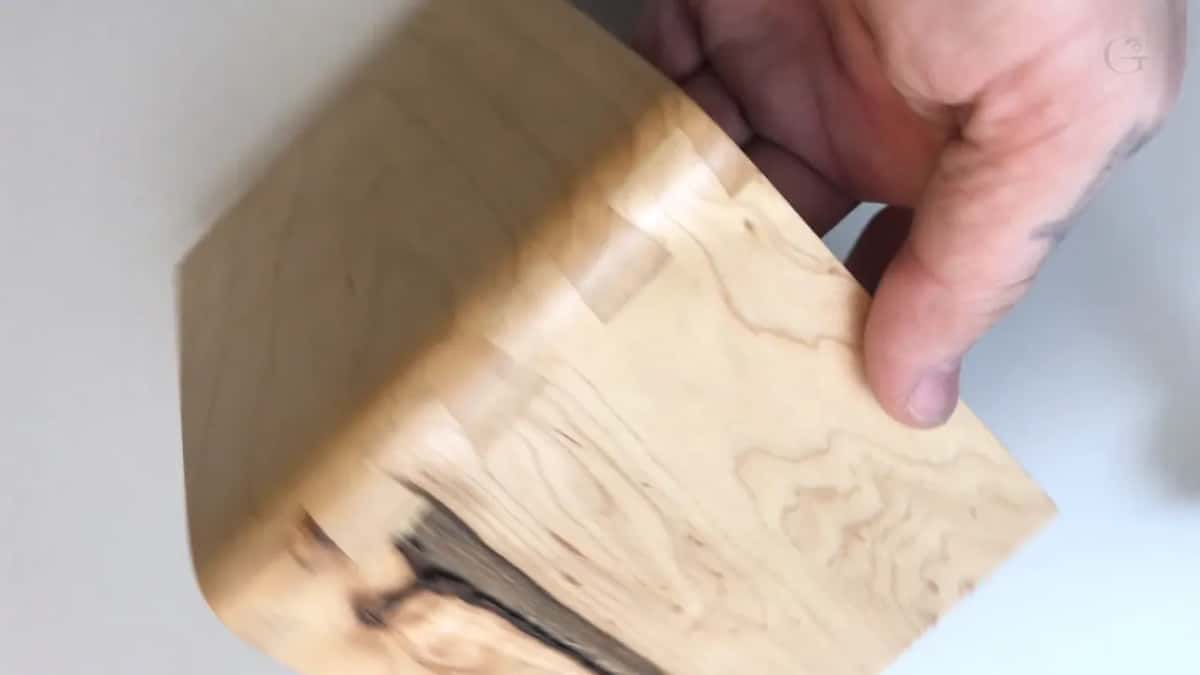 A pale offcut held up to the camera.