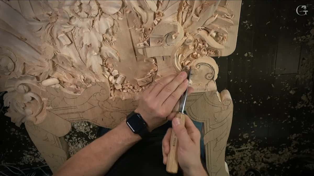 Tool nearly upright by the volute, left hand guiding the blade