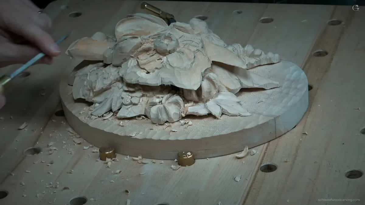 The whole piece on its round board, held by brass cams, a narrow blade coming in from the left