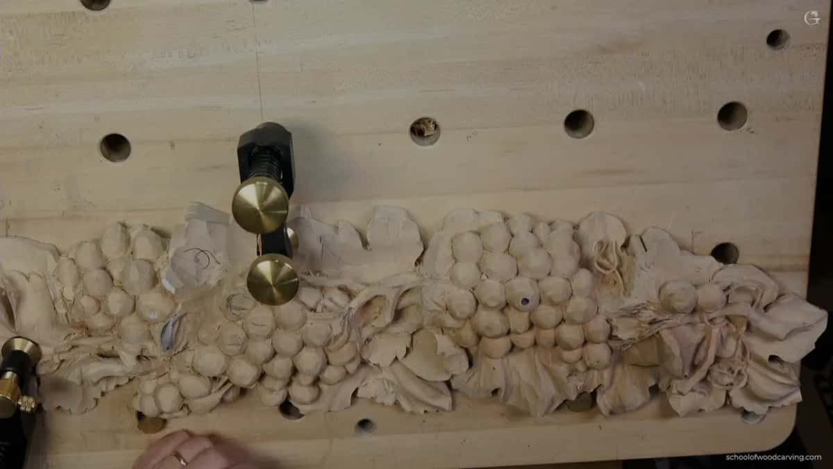 Whole panel from above with brass weights holding it, the vine now running the full length