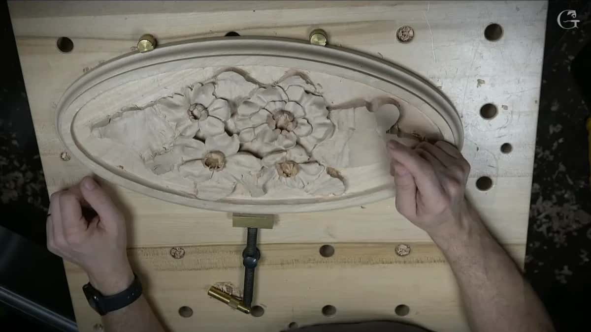 Both hands on an oval rosette