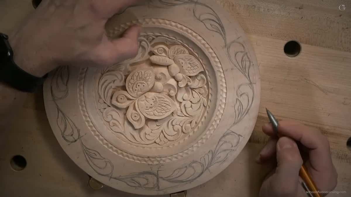 Fingertips rest on the carved center while the pencil waits beside the finished band