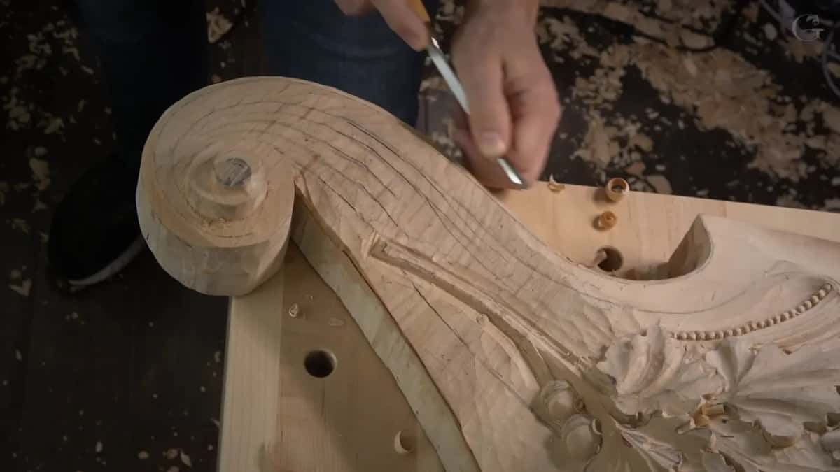 Small gouge in the inner curve, curled chips resting on the bench top.