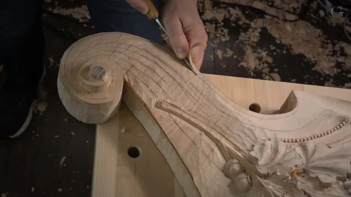 Gouge sliding along the scroll's neck.