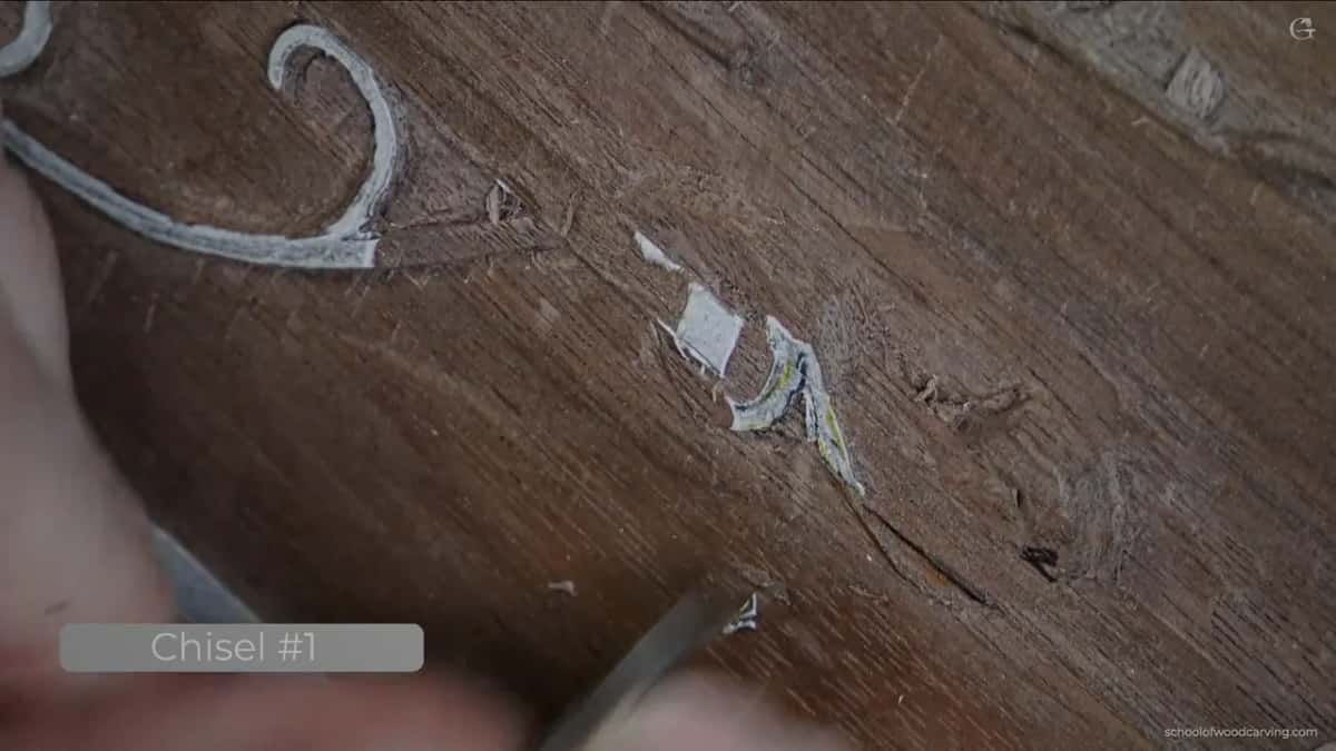 A chisel and a scatter of chips along the edge of the moulding.