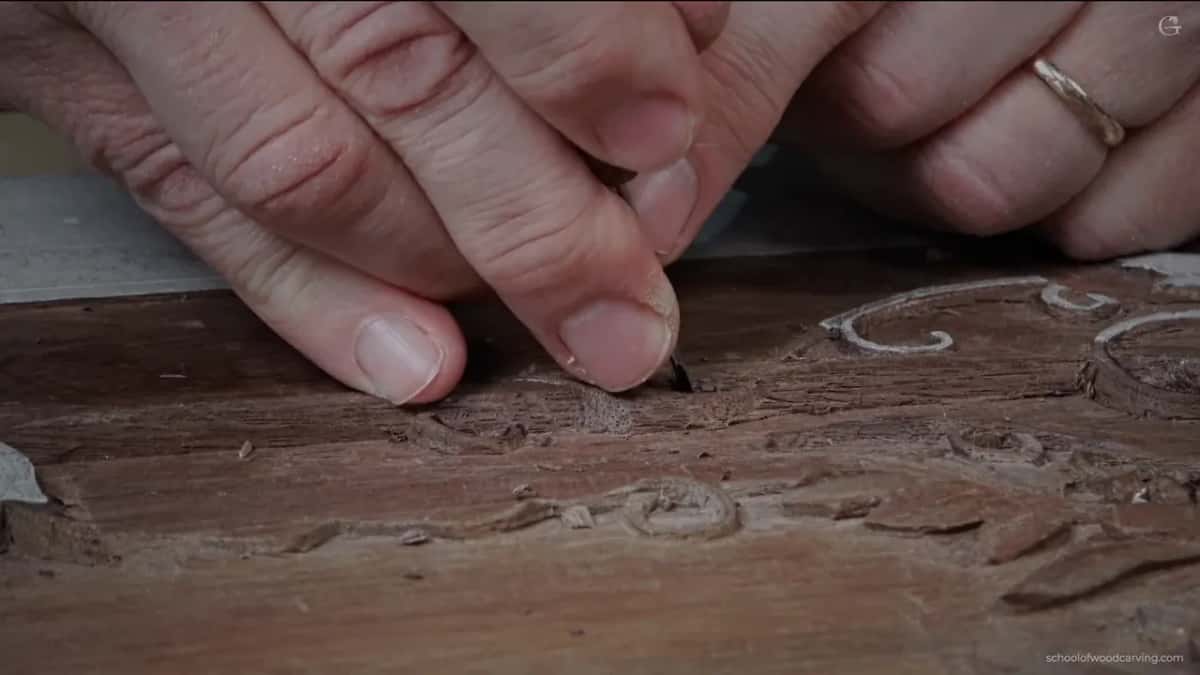 Two hands in close, pressed to the wood, and half of it is just moving waste.