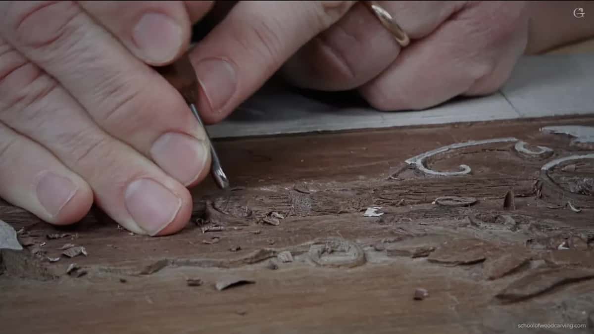 Fingers flat, a small tool, cuts of half a millimetre at a time.