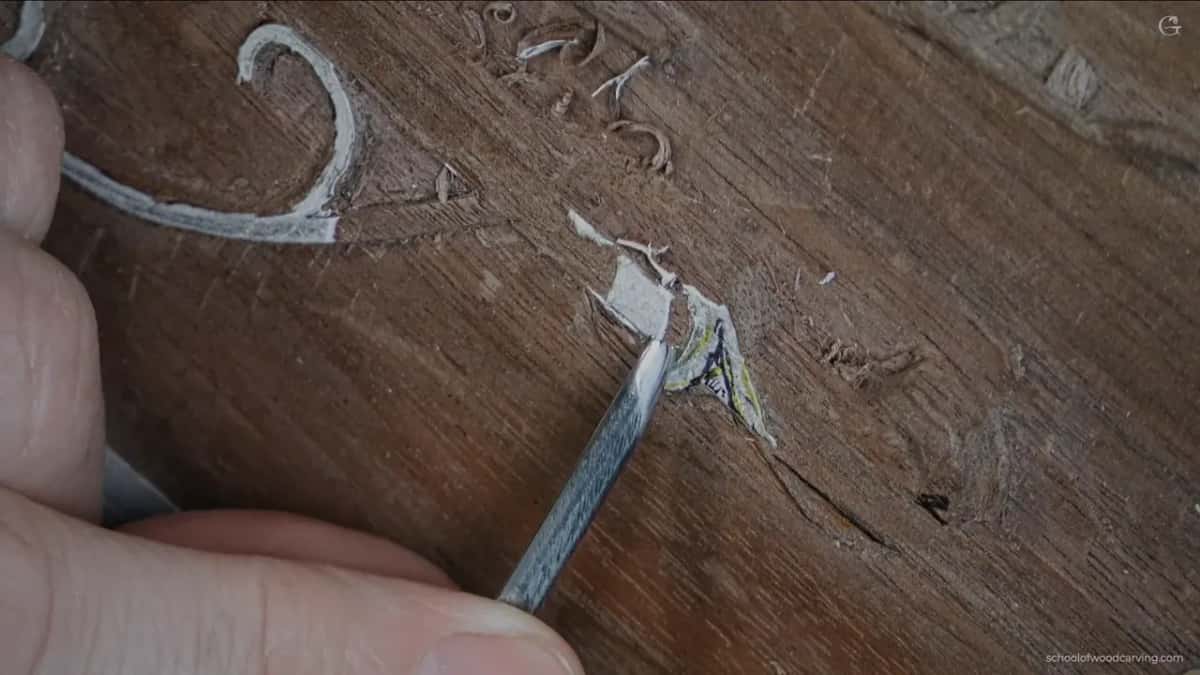 A scrap of paper and a blade at the carving.