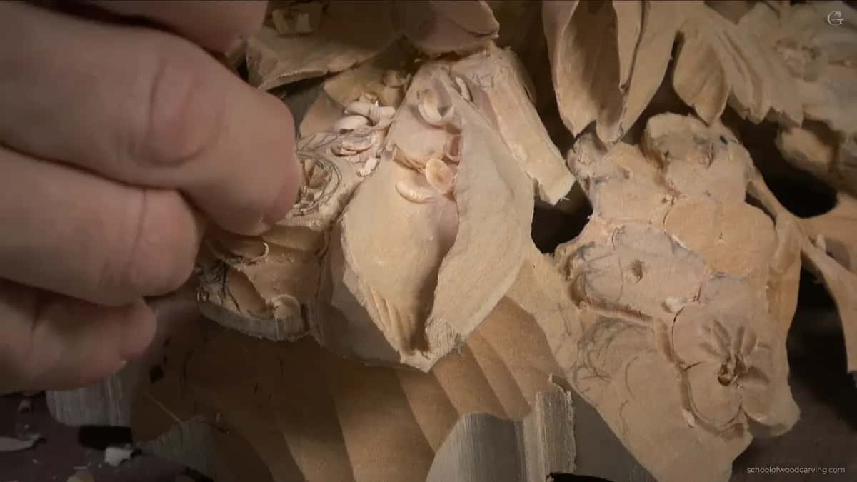 Fingers working at the center, shavings all around