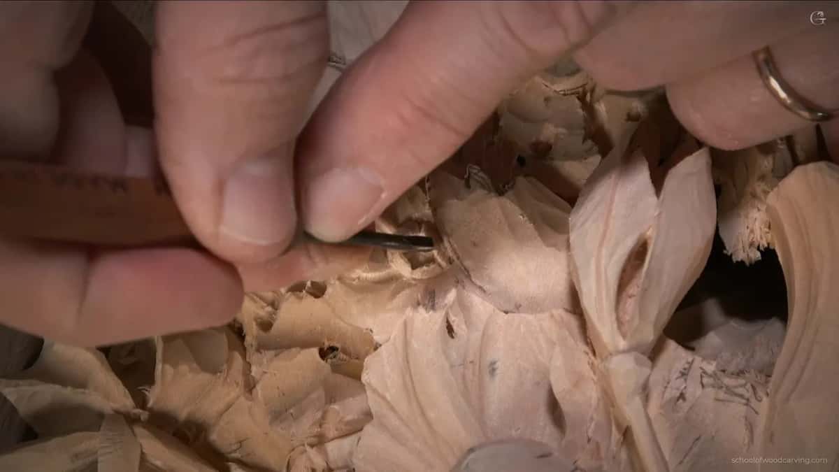 Fingers pinching a very small tool