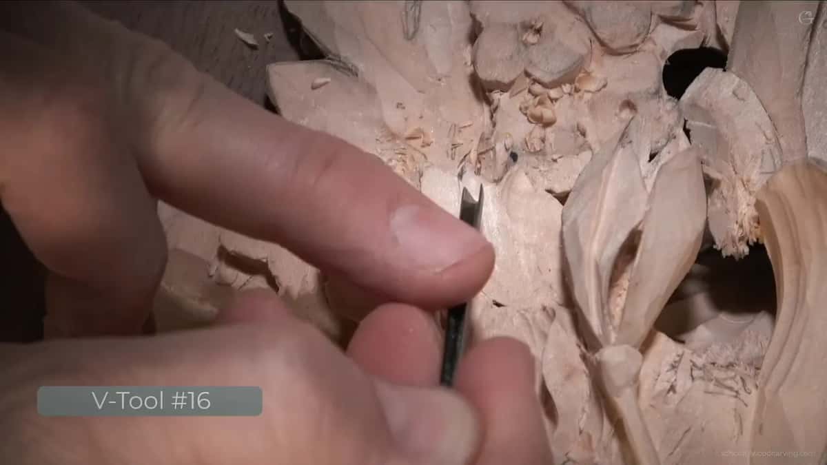 V-Tool #16 on the card, and the tool itself between thumb and finger drawing a long shallow line to direct the eye