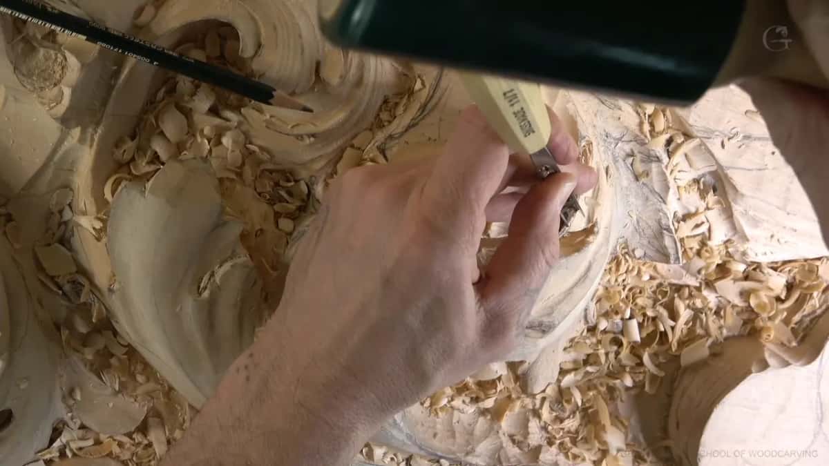 Pale-handled tool in hand, pencil up top.